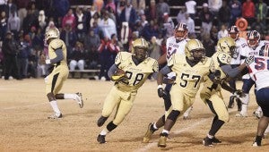 Tony Waits / The Prentiss Headlight – Junior Trodrick Daniels (#28) and Racheem Boothe (#57) easily advance down the field during the runaway South State Championship.