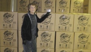 Tommy Broom / The Prentiss Headlight – Sara Johnson, Operation Shoe Box Coordinator, stands before a mountain of boxes loaded with children’s toys, hygiene and school supplies and a prayer for children across the globe.