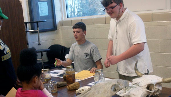 THE PRENTISS HEADLIGHT / KAREN SANFORD —Brogan Mason and John Ward, both 9th graders, show off a variety of skeletal organisms.