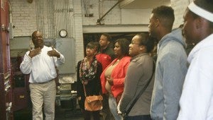 Karen Sanford / The Prentiss Headlight—Press operator Malcolm Stewart demonstrates to Bassfield journalism students the process for printing a newspaper.