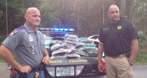 Mississippi Highway Patrol Captain Steven Shows and Jefferson Davis County Sheriff Ron Strickland with the estimated 200 lbs. of marijuana seized from the trunk of the suspect's car after a multi-county high speed chase ended in Jefferson Davis County.