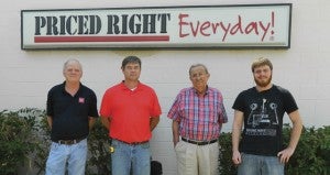 Shirley Burnham / The Prentiss Headlight—Speights Cash & Carry employees Danny Daniels, Shelley Barnes, Smoky the dog, Business owner R.C. Speights and employee Dustin Miles.